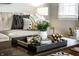 Close-up of a stylish coffee table featuring modern decor, plants, and books at 5140 Indianola Ave, Indianapolis, IN 46205