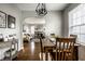 Dining and living area featuring hardwood floors, neutral walls, and seamless flow to other spaces at 5140 Indianola Ave, Indianapolis, IN 46205