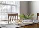 Dining area with a wooden table, chair, decorative centerpiece, and natural light from the window at 5140 Indianola Ave, Indianapolis, IN 46205