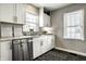 Bright kitchen featuring white cabinets, stainless steel appliances, and modern fixtures at 5140 Indianola Ave, Indianapolis, IN 46205