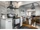 Open kitchen layout with stainless steel appliances and a view into the dining and living areas at 5140 Indianola Ave, Indianapolis, IN 46205