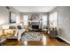 Stylish living room featuring a gray fireplace, hardwood floors, modern decor, and comfortable seating at 5140 Indianola Ave, Indianapolis, IN 46205