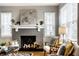Cozy living room featuring a brick fireplace, stylish decor, and natural light at 5140 Indianola Ave, Indianapolis, IN 46205