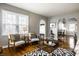 Bright living room with hardwood floors, neutral walls, and an open archway to the dining area at 5140 Indianola Ave, Indianapolis, IN 46205