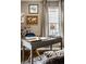 A well-organized desk area with neutral colors, decor and natural light, enhancing productivity at 5140 Indianola Ave, Indianapolis, IN 46205