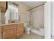 A bathroom has a shower-tub combination, a toilet, a mirror, and a vanity with sink at 5213 Milhouse Rd, Indianapolis, IN 46221