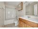 A bathroom has a shower-tub combination, a toilet, a mirror, and a vanity with sink at 5213 Milhouse Rd, Indianapolis, IN 46221
