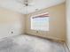 Bedroom featuring a window with blinds, electrical outlets, and a ceiling fan at 5213 Milhouse Rd, Indianapolis, IN 46221