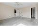 A bedroom is shown with doorways, a ceiling fan, and a window at 5213 Milhouse Rd, Indianapolis, IN 46221