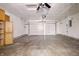 Spacious garage featuring a ceiling fan, ample storage, and a clean, functional space at 5213 Milhouse Rd, Indianapolis, IN 46221