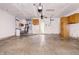 Functional garage space with a utility sink, water heater, and storage cabinets at 5213 Milhouse Rd, Indianapolis, IN 46221