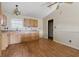 Kitchen featuring wooden cabinets, a window above the sink, and a ceiling fan at 5213 Milhouse Rd, Indianapolis, IN 46221