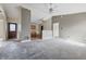 Open-concept living room leading to the kitchen, with a ceiling fan and multiple doorways at 5213 Milhouse Rd, Indianapolis, IN 46221