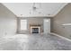 A living room is shown with a fireplace, a window, a ceiling fan, and a doorway at 5213 Milhouse Rd, Indianapolis, IN 46221