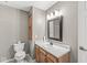 Bathroom featuring a toilet, sink, vanity, and mirror at 5324 Rolling Meadow Blvd, Indianapolis, IN 46237