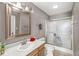 Bathroom featuring a framed mirror, oak vanity, and glass-enclosed shower at 5324 Rolling Meadow Blvd, Indianapolis, IN 46237