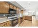 Kitchen with stainless steel appliances, wood cabinets, and hardwood floors at 5324 Rolling Meadow Blvd, Indianapolis, IN 46237