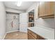 Laundry room adjacent to the kitchen with open shelving and washer/dryer hookups at 5324 Rolling Meadow Blvd, Indianapolis, IN 46237