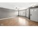Bright living room with hardwood floors, a ceiling fan, and large windows offering ample natural light and a welcoming ambiance at 5324 Rolling Meadow Blvd, Indianapolis, IN 46237