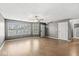 Inviting living room featuring hardwood floors, a ceiling fan, and large windows, perfect for relaxation and entertaining at 5324 Rolling Meadow Blvd, Indianapolis, IN 46237