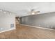 Open-concept living space showcasing hardwood floors, a ceiling fan, and a seamless transition to the kitchen area at 5324 Rolling Meadow Blvd, Indianapolis, IN 46237