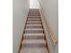 Staircase with carpet steps and wood banister at 5324 Rolling Meadow Blvd, Indianapolis, IN 46237