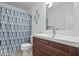 A bathroom with a modern vanity and a shower with a patterned curtain at 549 Keystone Ave, Indianapolis, IN 46201