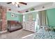 View of a delightful bedroom with a crib, wooden dresser, and a charming single bed at 549 Keystone Ave, Indianapolis, IN 46201