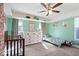 Bright bedroom with a ceiling fan, plush carpet, and a whimsical collection of decorations and furnishings at 549 Keystone Ave, Indianapolis, IN 46201
