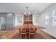 Dining room area with views into the kitchen, wood floors, and stylish decor at 549 Keystone Ave, Indianapolis, IN 46201