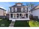 Charming two-story home with a welcoming front porch and well-manicured lawn at 549 Keystone Ave, Indianapolis, IN 46201