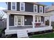 Close-up of the home's charming front porch with decorative pillars and inviting seating at 549 Keystone Ave, Indianapolis, IN 46201