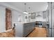 Modern kitchen with stainless steel appliances, gray cabinets, and a central island at 549 Keystone Ave, Indianapolis, IN 46201