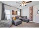 Inviting living room featuring a gray sectional sofa, a beanbag chair, and a decorative exposed brick element at 549 Keystone Ave, Indianapolis, IN 46201