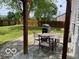 Backyard featuring a patio, a grill, a dining table with chairs, and a wooden fence, perfect for outdoor entertaining at 563 Jet Stream Blvd, Westfield, IN 46074