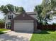 Charming two-story home featuring a brick two-car garage, well-maintained lawn, and mature trees, offering great curb appeal at 563 Jet Stream Blvd, Westfield, IN 46074
