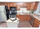 Bright kitchen with stainless steel appliances, island, and wooden cabinetry at 5713 Bradston Way, Indianapolis, IN 46237
