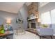 Living room with a stone fireplace, neutral decor, and ample natural light at 5713 Bradston Way, Indianapolis, IN 46237