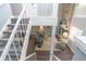 View of the living room from the second-floor hallway with stone fireplace at 5713 Bradston Way, Indianapolis, IN 46237