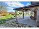 Exterior view of a brick home with a covered patio overlooking a pool and a well-manicured lawn at 601 Ridge Rd, Greenwood, IN 46142
