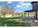 Backyard featuring a covered patio with outdoor seating, a pool, and a lush green lawn at 601 Ridge Rd, Greenwood, IN 46142
