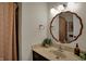 Bathroom featuring decorative mirror, updated vanity, unique lighting, and stylish decor at 601 Ridge Rd, Greenwood, IN 46142