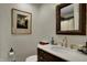 Bathroom with wood vanity, framed mirror, and gold faucet at 601 Ridge Rd, Greenwood, IN 46142