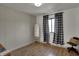 Bright bedroom with checkered curtains, mirror and wood floors at 601 Ridge Rd, Greenwood, IN 46142