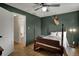 Cozy bedroom with unique green walls, vintage four-poster bed, and bright window views at 601 Ridge Rd, Greenwood, IN 46142