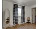 Bright bedroom with checkered curtains, mirror and wood floors at 601 Ridge Rd, Greenwood, IN 46142