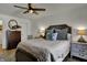 Cozy bedroom featuring a comfortable bed with decorative pillows, ceiling fan, and wood floors at 601 Ridge Rd, Greenwood, IN 46142