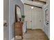 Light-filled entryway with wood floors, a classic dresser, and a charming decorative mirror at 601 Ridge Rd, Greenwood, IN 46142