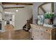 Light-filled entryway with wood floors, open stairs, and a view of a beautifully remodeled kitchen at 601 Ridge Rd, Greenwood, IN 46142