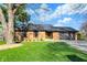 Charming brick home with an attached garage, mature tree, and beautifully landscaped front yard at 601 Ridge Rd, Greenwood, IN 46142